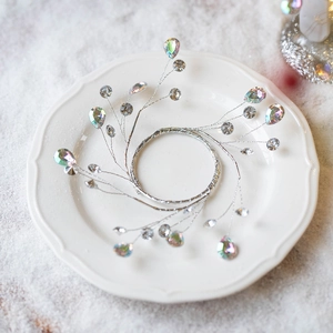 Silver acrylic diamond Christmas tree wreath with sparkling crystals on white dish