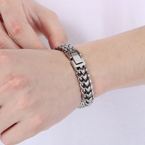 Mens bold stainless steel dragon bone chain bracelet with polished finish on wrist