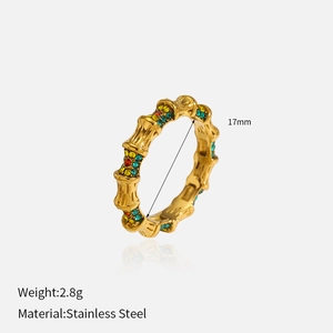 Macro detail of a golden bamboo-style stainless steel ring with colorful gemstones