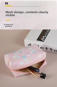 Detail of pink quilted cosmetic bag featuring heart prints and inner makeup brushes