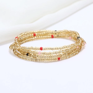 Close-up of double-layer golden glass seed bead waist chain for beach bikini jewelry