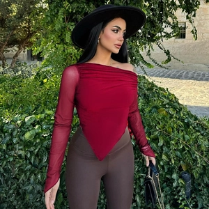 Detail of burgundy mesh top featuring pleated texture and irregular pointed hem design