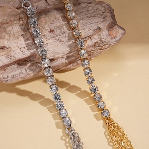 Elegant geometric rhinestone body chain with tassel details in gold and silver finish