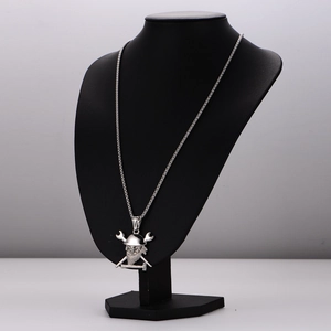 Vintage silver pirate skull necklace with wrench crossbones on a black mannequin display
