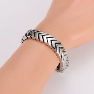Men's punk style stainless steel snake bone bracelet with V-shaped links on model arm