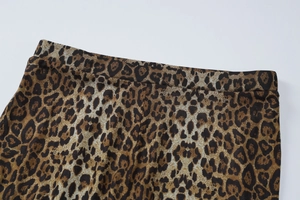 Detailed close-up of leopard print fabric texture and elastic waistband stitching