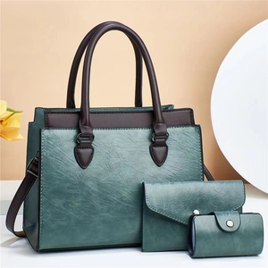 Three-piece turquoise and brown faux leather handbag set with tote, wallet, and card holder
