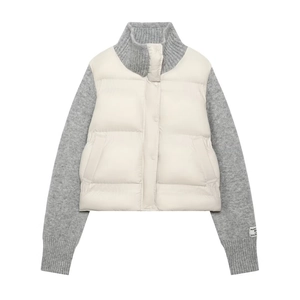 Quilted off-white jacket with grey knit sleeves and stand collar featuring snap buttons