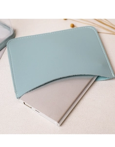 Macro shot of light blue leather mini bag stitching and silver power bank fit