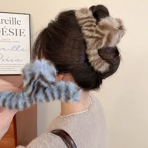 Elegant plush acrylic hair claw clips in brown and blue tiger patterns for winter styling