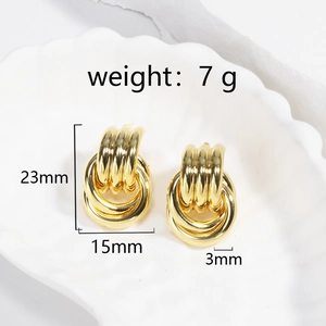 Detail of gold layered knot earrings showing 23mm height and 15mm width dimensions