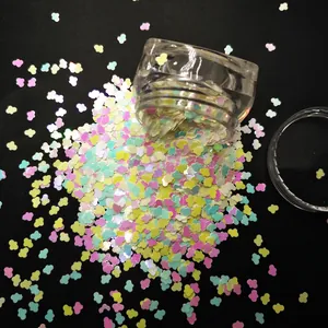 Mix of colorful mini cloud-shaped glitter sequins in a clear jar for nail art and DIY