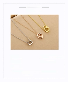 Close-up of interlocking heart pendants in silver, gold, and rose gold titanium steel