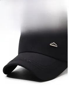 Detail of black baseball cap featuring a metal mountain badge and brim embroidery
