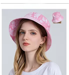 Detail view of pink tie-dye sun hat with wide brim showing front and back texture