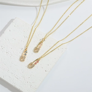 French retro gold choker necklace with safety pin pendant and colorful devil eye stones