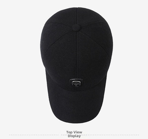 Top view of a black wool baseball cap featuring a premium metallic shield emblem