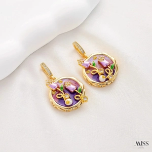 Detailed close-up of a vintage golden flower pendant with purple enamel and a pearl