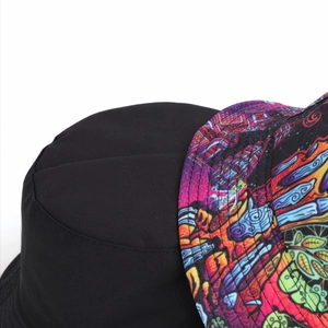 Detail of reversible bucket hat showing black twill side and colorful graffiti print