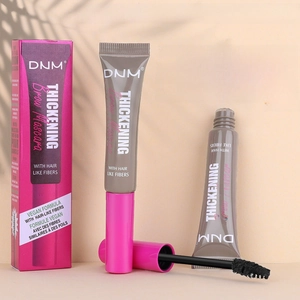 Detail view of DNM eyebrow styling gel with brush and vegan fiber formula packaging