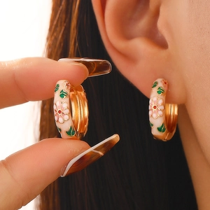 Vintage Chinese style hoop earrings featuring pink floral enamel and golden finish