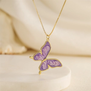 Golden chain necklace featuring a purple butterfly pendant with marble enamel finish