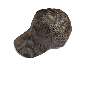 Detail of black baseball cap with metallic gold dots and structured six-panel design