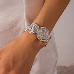 Gros plan détaillé du bracelet en métal argenté avec textures rondes en spirale