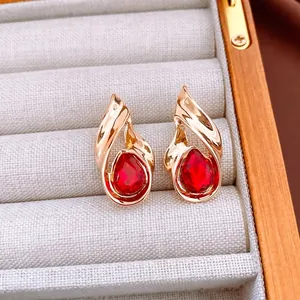 Vintage water drop earrings with deep red pear-cut crystals in a gold twist setting