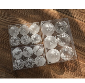 Detail view of 6cm clear Christmas ornaments with white snowflakes on dark wood background