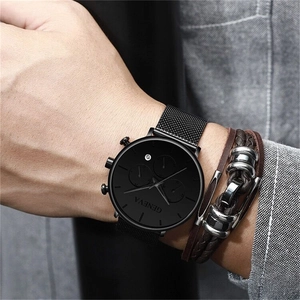 Close-up of Geneva men's black quartz mesh watch paired with a brown leather bracelet