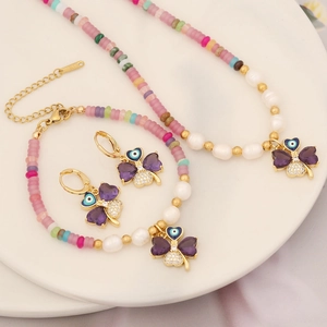 Purple clover jewelry set with evil eye charm, pearls and gold beaded chain detail