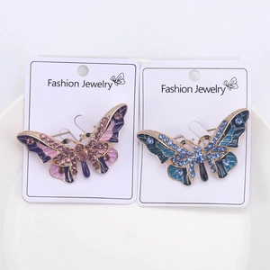 Close-up of alloy butterfly brooches with colorful enamel finish and crystal rhinestones