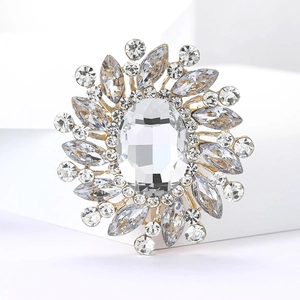 Macro detail of luxury flower brooch with large oval crystal and marquise rhinestones