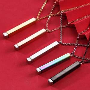 Five polished bar pendant necklaces in gold, rose gold, silver, rainbow, and black on red