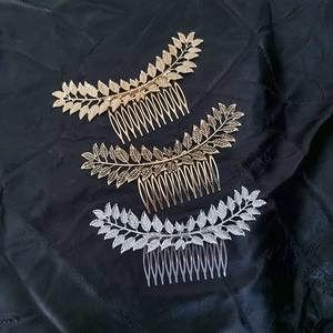 Vintage leaf alloy hair combs set in gold, silver, and bronze finishes on black fabric