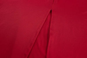 Detail view of the high-quality stitching and slit design on this red bodycon dress