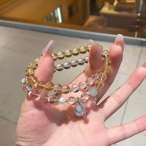Macro shot of natural chalcedony and quartz beaded bracelet with pearls and pendants