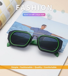 Detail view of retro square sunglasses with black frame and neon green interior on magazine