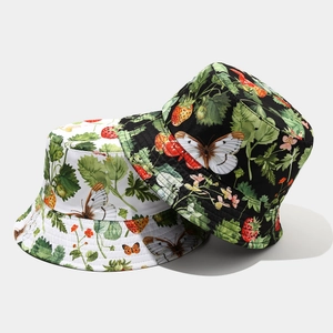 Detail of reversible bucket hat with strawberry and butterfly prints on black and white cotton