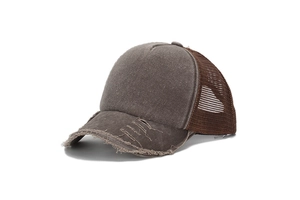 Detailed view of the distressed vintage trucker hat with frayed brim and mesh back