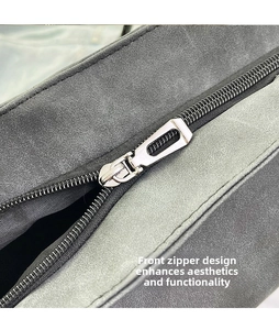 Macro detail of high-quality suede fabric texture and silver metal front zipper teeth
