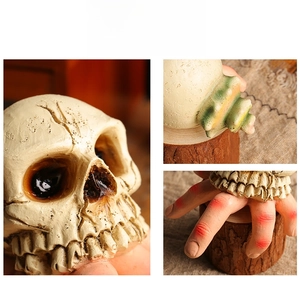 Macro detail of realistic resin skull statue showing weathered texture and wood base