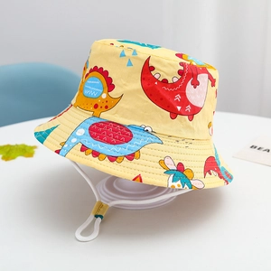 Detail of yellow kids bucket hat with colorful dinosaur prints and adjustable chin strap