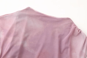 Close-up of pink gradient mesh fabric with elegant pleated details and round neckline