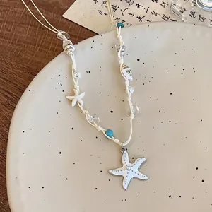 Détail du pendentif étoile de mer avec coquillages naturels et collier de perles coloré