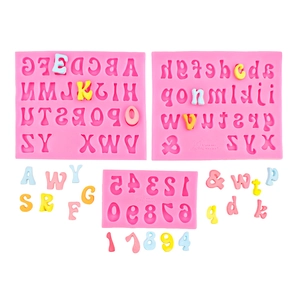 Pink silicone alphabet and number molds with colorful fondant letters for cake decorating