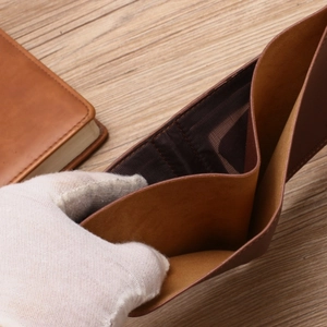 Slim brown leather bifold wallet for men featuring multiple card slots and bill compartment