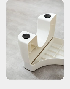 Detail of the reinforced grid structure and anti-slip pads under the white toilet stool