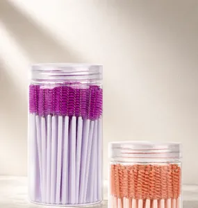 Detail view of 100pcs disposable mascara wands in a clear tube for eyebrow and lash care